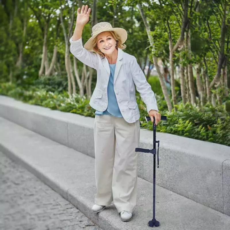 Detail of the LED light on the foldable walking stick, illuminating path with non-slip four-point base.