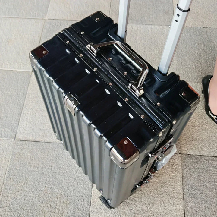Unisex hard shell suitcase with smooth spinner wheels, aluminum frame, & spacious interior for travel.