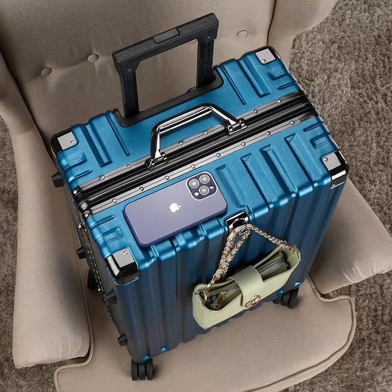 Smooth-gliding spinner wheels on a unisex hard shell travel suitcase with secure aluminum frame.