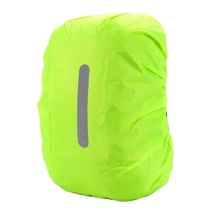 Reflective backpack rain cover protecting a hiking backpack from heavy rain on a trail.