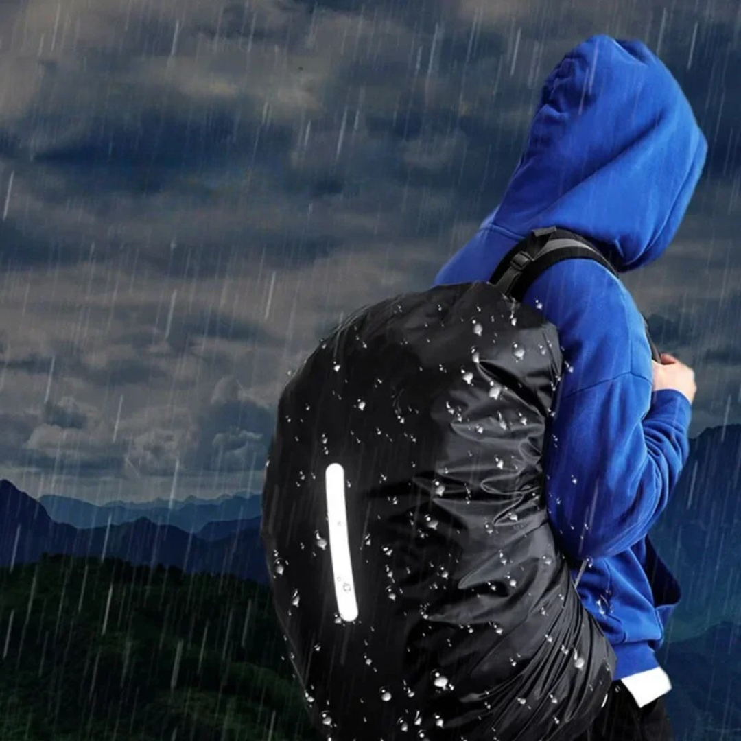 Bright reflective lightweight rain cover securely fitted on a black backpack in daylight.
