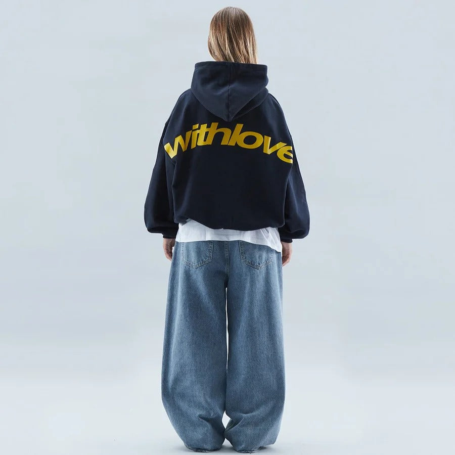 Stylish urban oversized hoodie, unisex, featuring a prominent slogan print; great for modern streetwear.