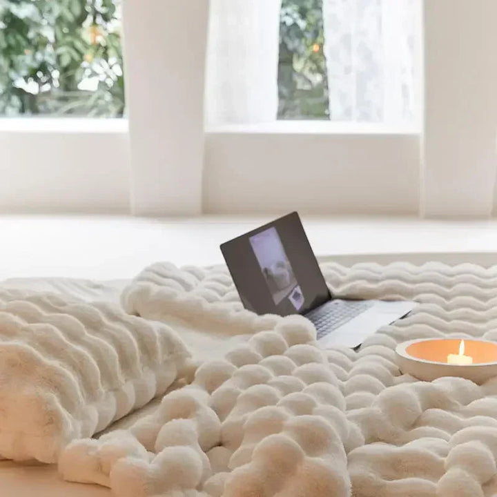 Machine washable plush fleece blanket, offering comfortable warmth and soft home decor.
