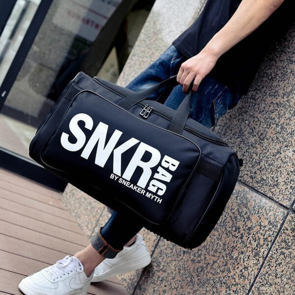 Unisex water-resistant sneaker travel bag with multiple compartments for shoes and gear.