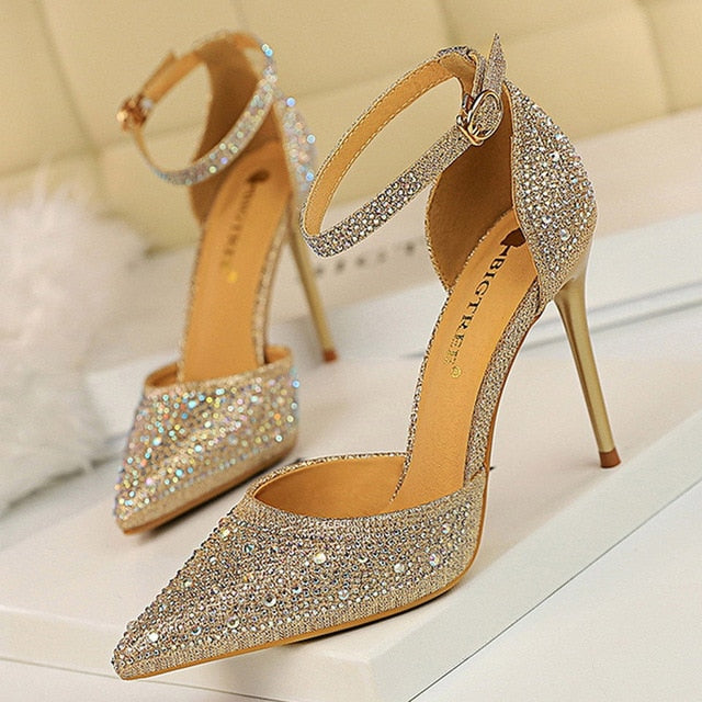 Sparkling women's stiletto sandals with a dazzling rhinestone ankle strap, perfect for glamorous events.