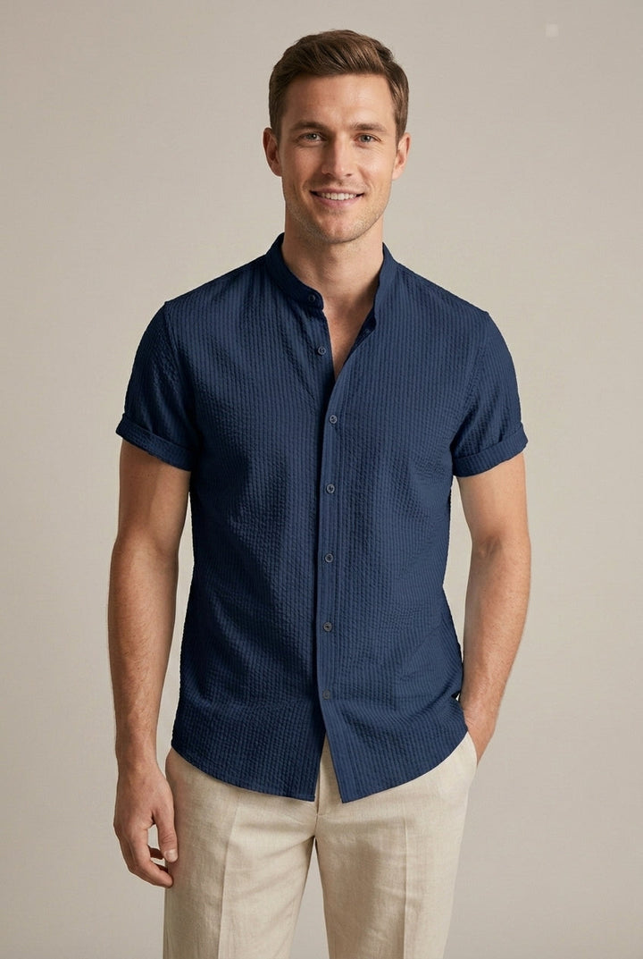 Close-up of textured men's short sleeve summer shirt with a band collar and button front. Casual summer fashion.