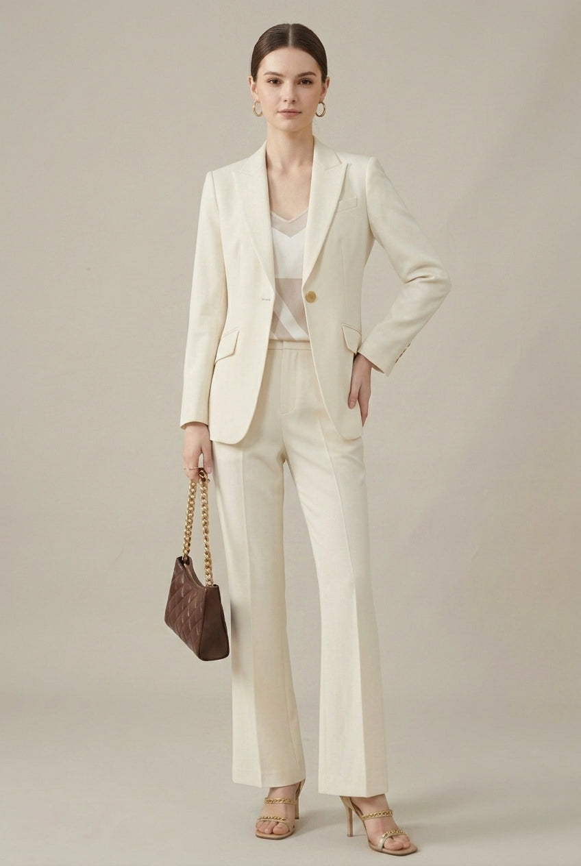 Formal women's elegant tailored pant suit with detailed gold buttons for a sophisticated business look.