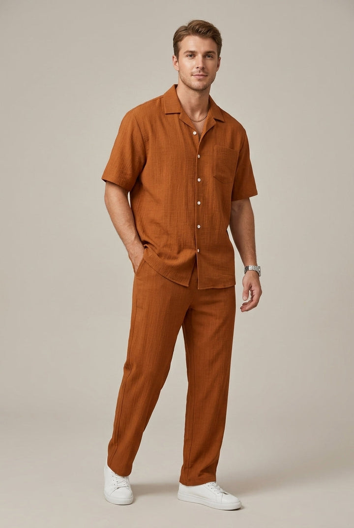 Men's fashion coordinated two-piece set: a textured short-sleeve shirt and matching drawstring trousers for casual wear.