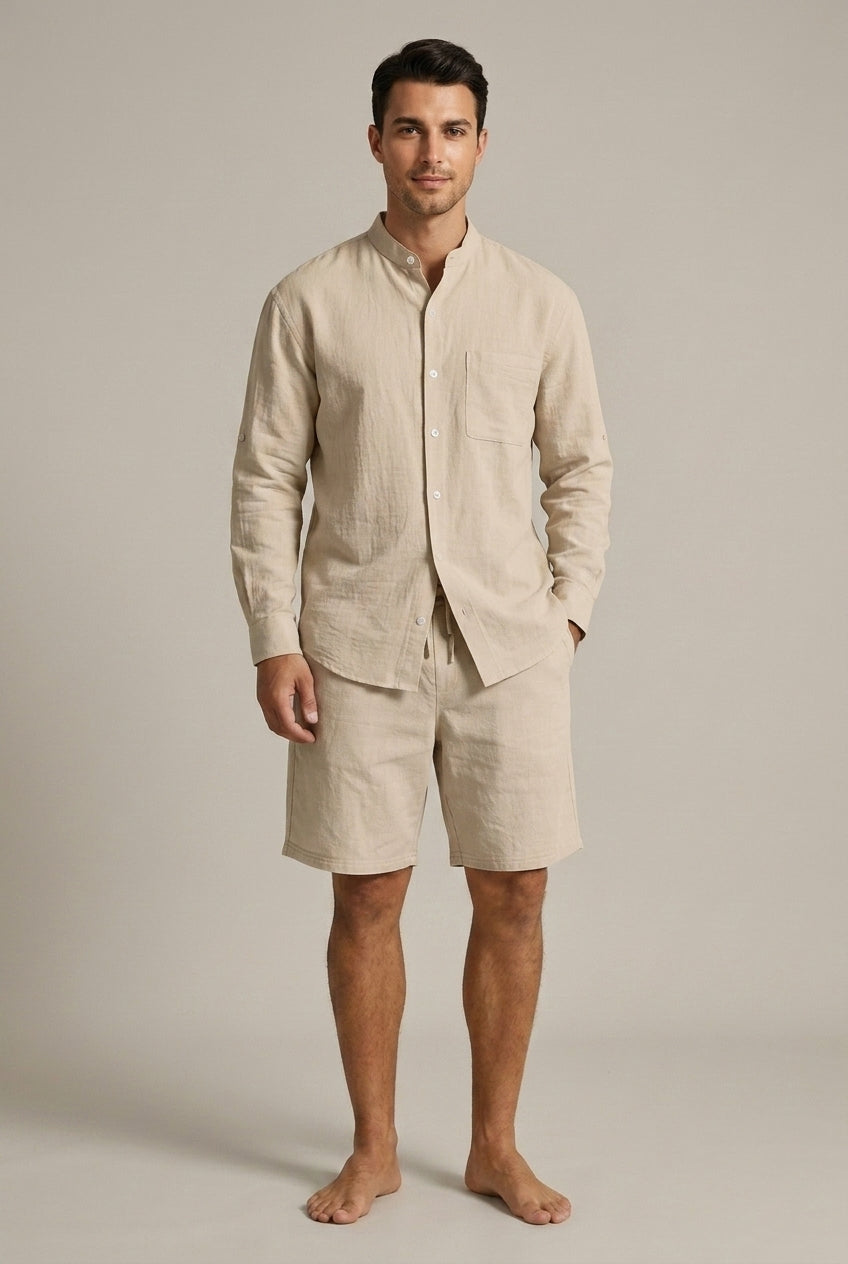 Man wearing a light, relaxed men's band collar shirt and matching shorts, perfect for summer vacation.