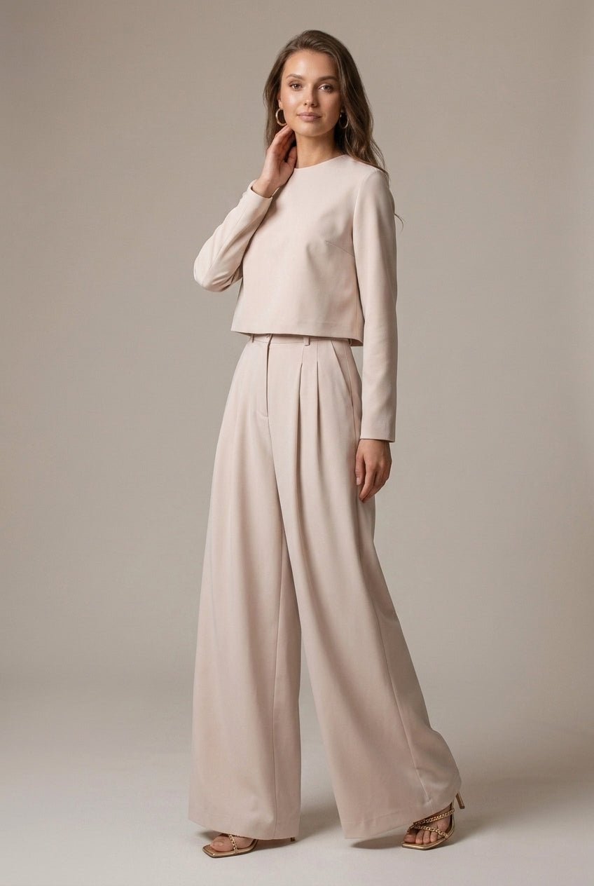 Professional women's two-piece wide-leg palazzo suit with crop top, versatile for work or elegant events.