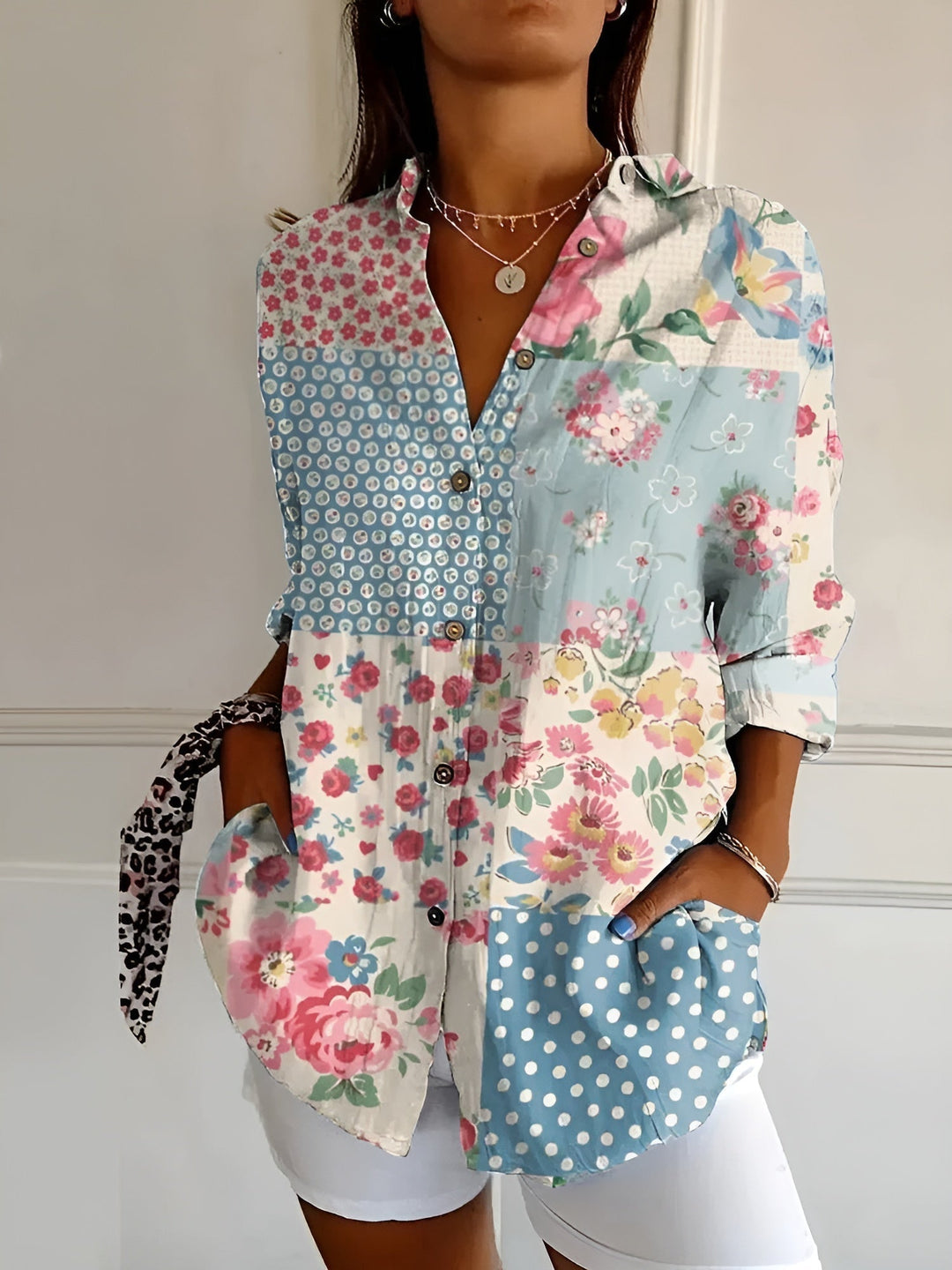 Stylish women's printed blouse, button-front, with rolled three-quarter sleeves. Versatile fashion top.