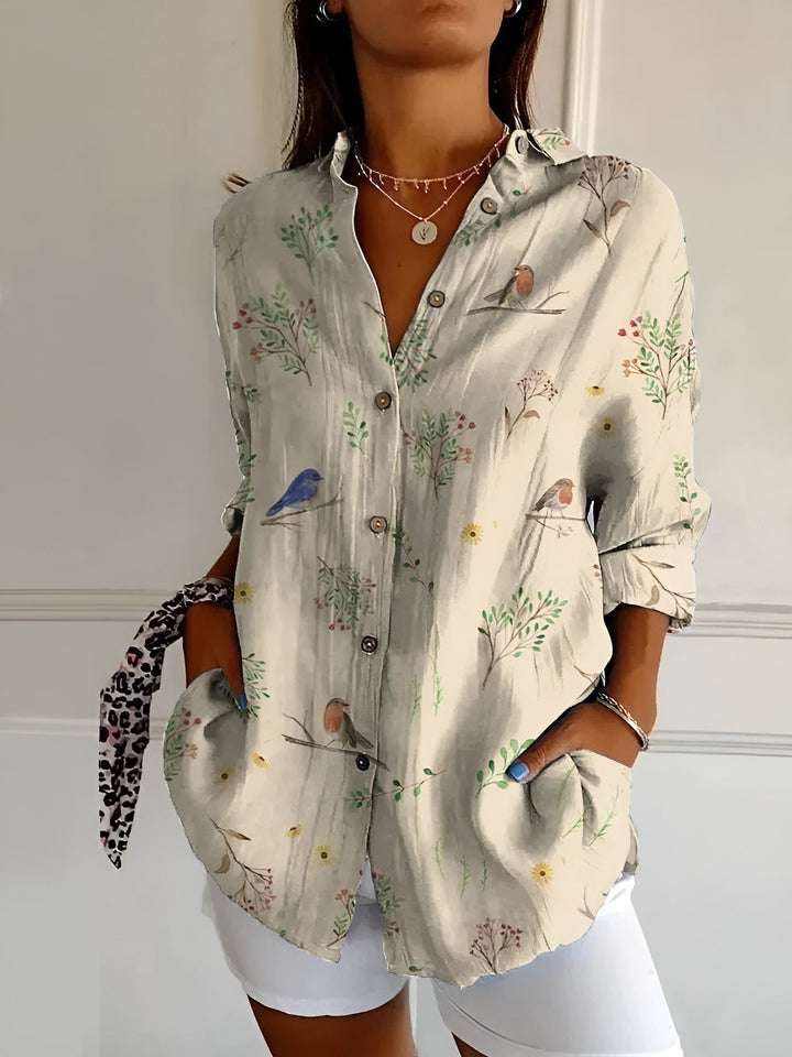 Versatile patterned button-front blouse for women. Three-quarter rolled cuffs, ideal for casual chic spring wear.