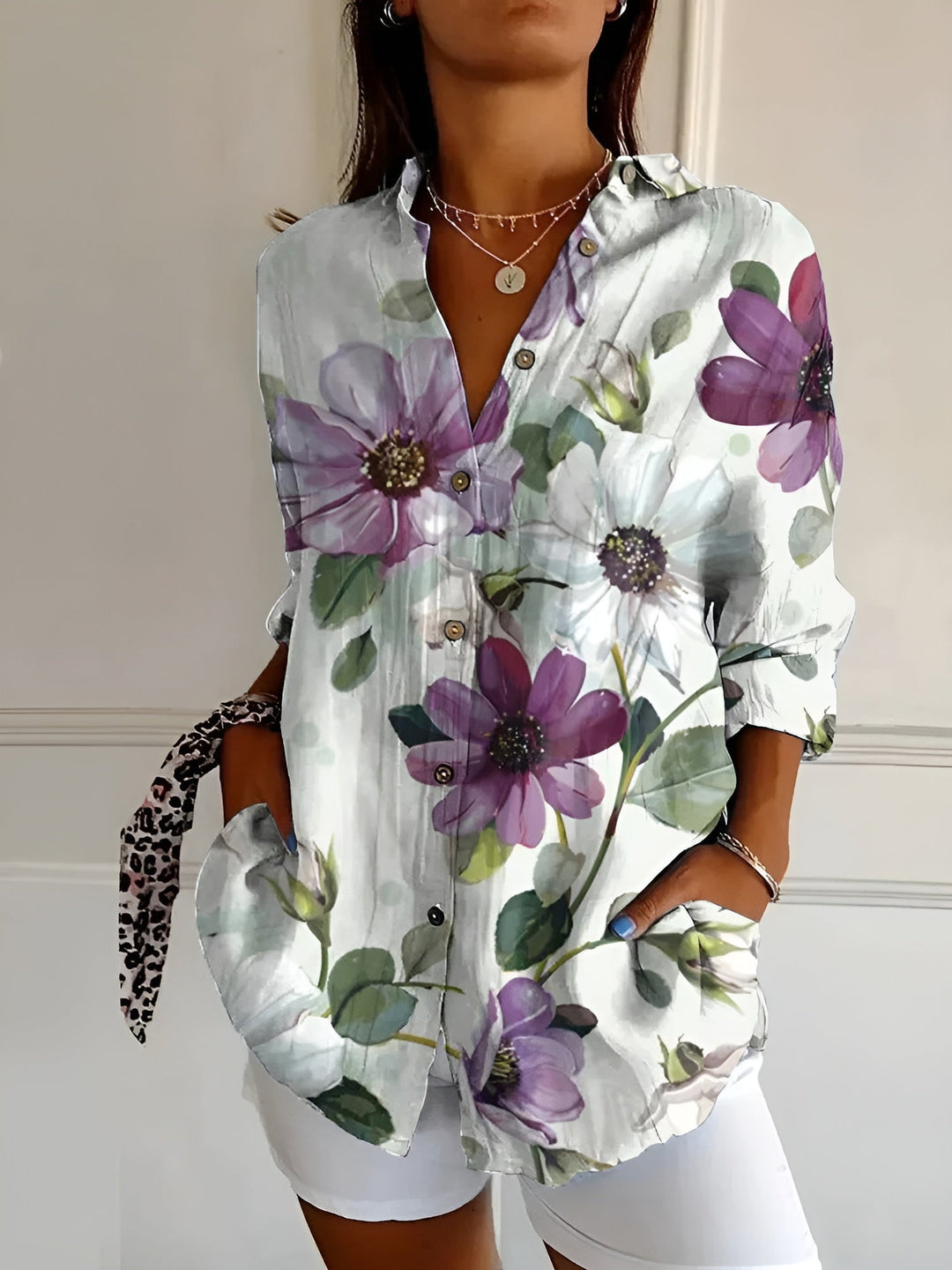 Women's collared printed button-front blouse with stylish rolled 3/4 sleeves. A versatile fashion top.