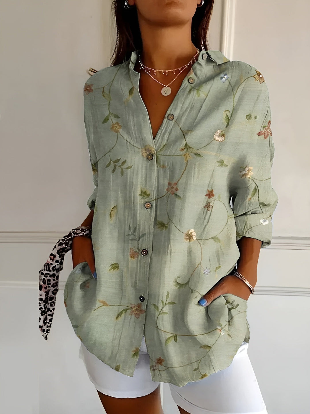 Casual chic women's patterned button-front blouse. Elegant collared top with three-quarter rolled cuffs.