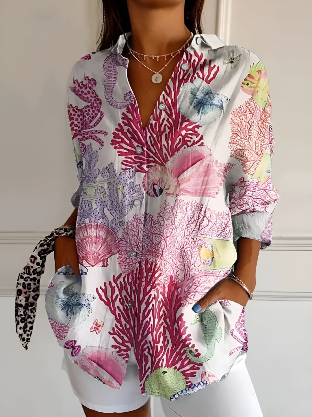 Elegant women's collared blouse featuring a vibrant print & button-front. Rolled 3/4 sleeves, perfect for summer.