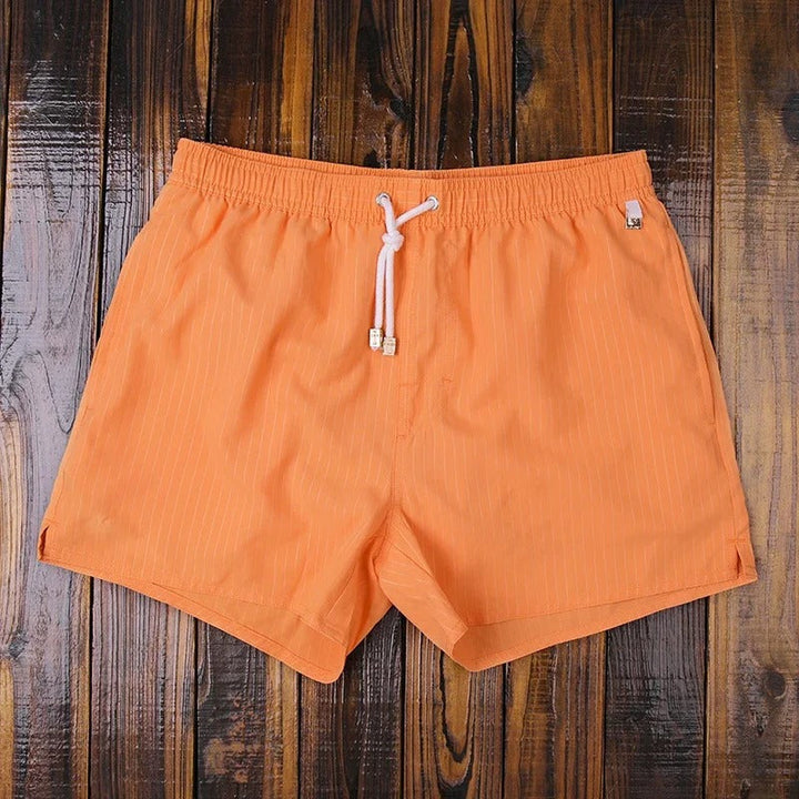 Comfortable men's quick-dry swim shorts for versatile beachwear, stylish summer fashion, and vacation.
