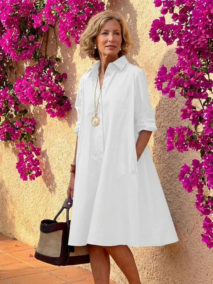 Versatile women's long-sleeve midi shirt dress, button front & collared, perfect for summer travel or spring casual outings.