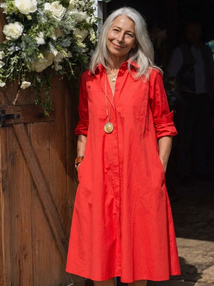 Relaxed fit women's midi shirt dress featuring button front, collared neckline, long sleeves, & practical pockets.