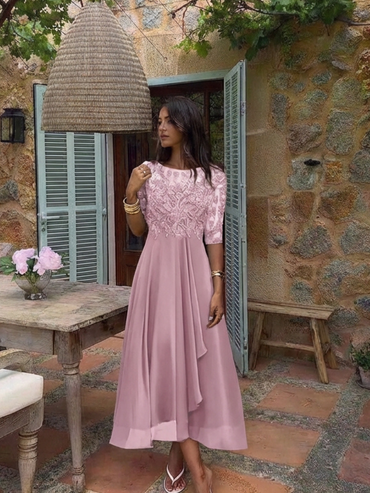 Women's flattering lace midi dress. Elegant design with three-quarter sleeves, suitable for special occasions.