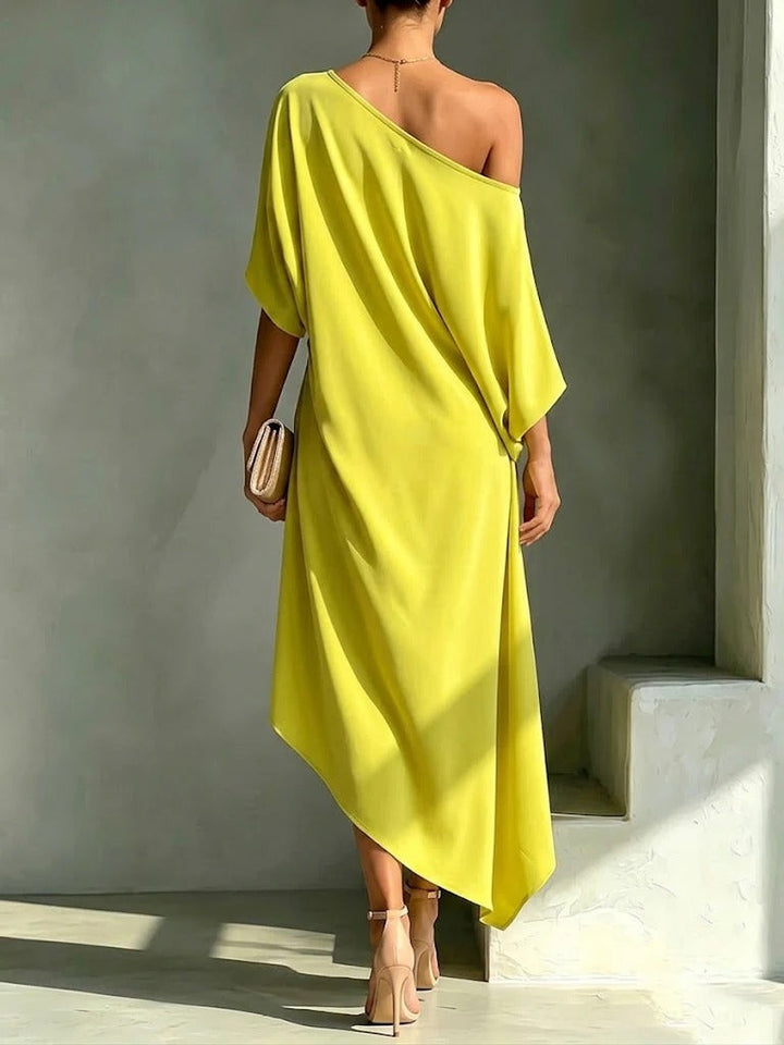 Women's elegant yellow asymmetrical maxi dress, flowy & chic, perfect one-shoulder evening wear for special occasions.