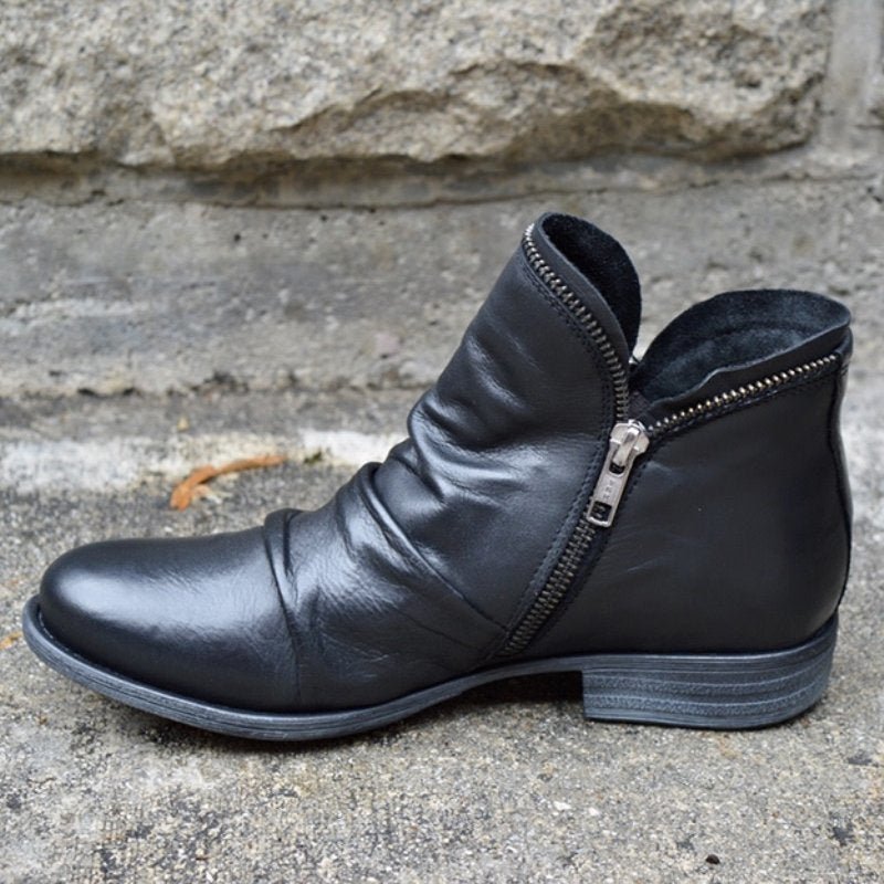 Chic women's black leather ankle boots with side zip & low heel, perfect for versatile fall & winter fashion.