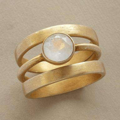 Elegant women's gold & moonstone intarsia ring, a fine jewelry statement piece. Versatile and luxurious accessory.