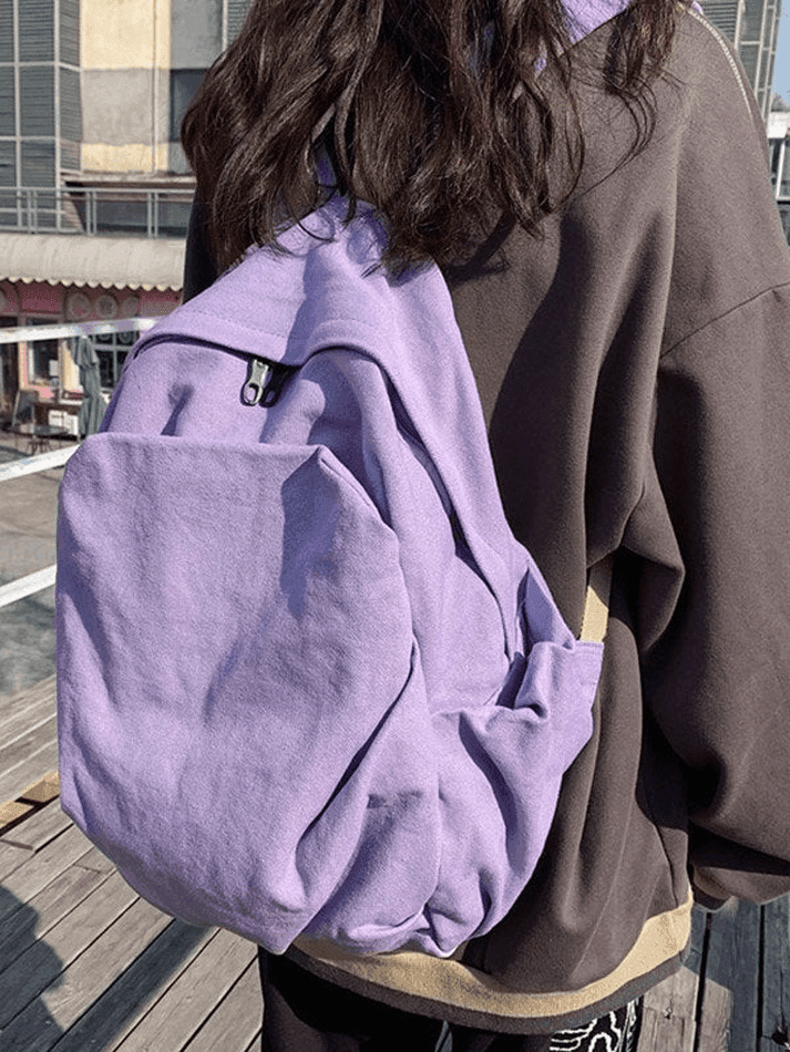 Lilac vintage wash canvas backpack, a trendy school and college bag for all students.