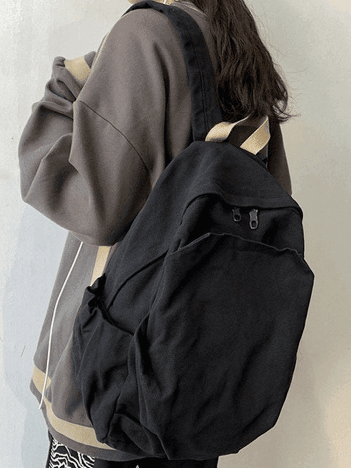 Unisex vintage wash black canvas backpack, perfect for college and school everyday carry.