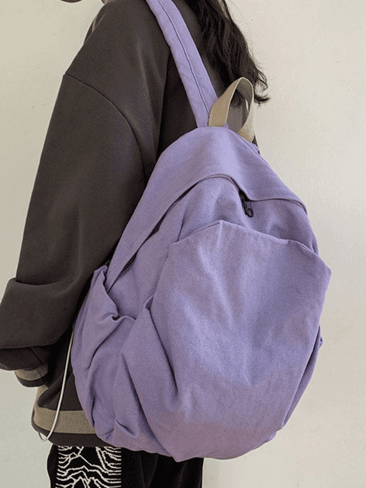 Black vintage wash canvas school backpack, unisex and spacious for students' essentials.