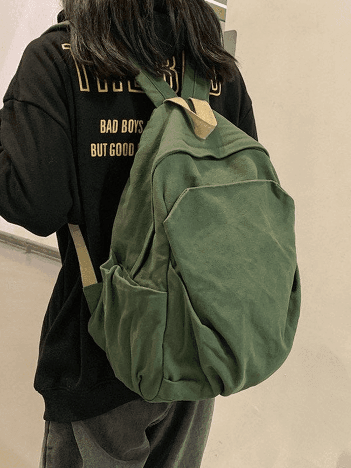 Distressed look green canvas college backpack, vintage wash for students' everyday carry.