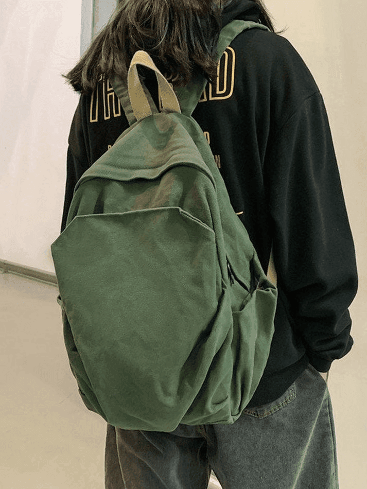 Green vintage wash college backpack, versatile canvas design for everyday carry items.
