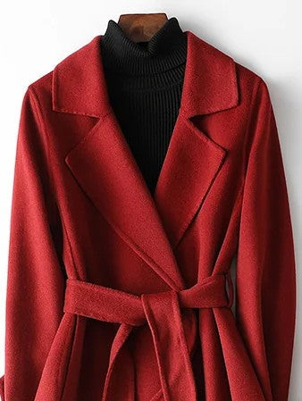 Stylish women's long wrap coat in burgundy, featuring a flattering A-line cut and chic belt for winter fashion.