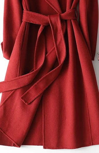 Elegant women's belted wrap coat, a classic A-line long outerwear piece in burgundy for sophisticated fall style.