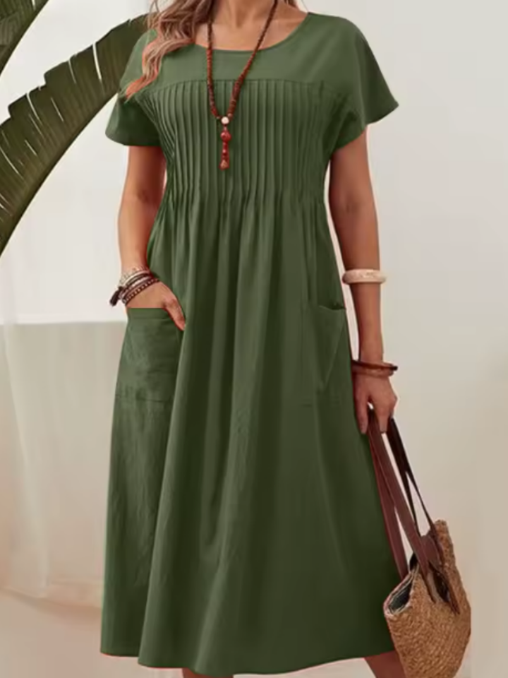 Stylish women's midi dress featuring a pleated bodice, short sleeves, and a relaxed fit. Elegant for day or evening wear.