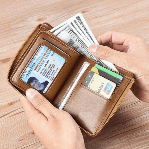 Man holding a slim black anti-theft leather wallet, perfect for everyday carry & security.