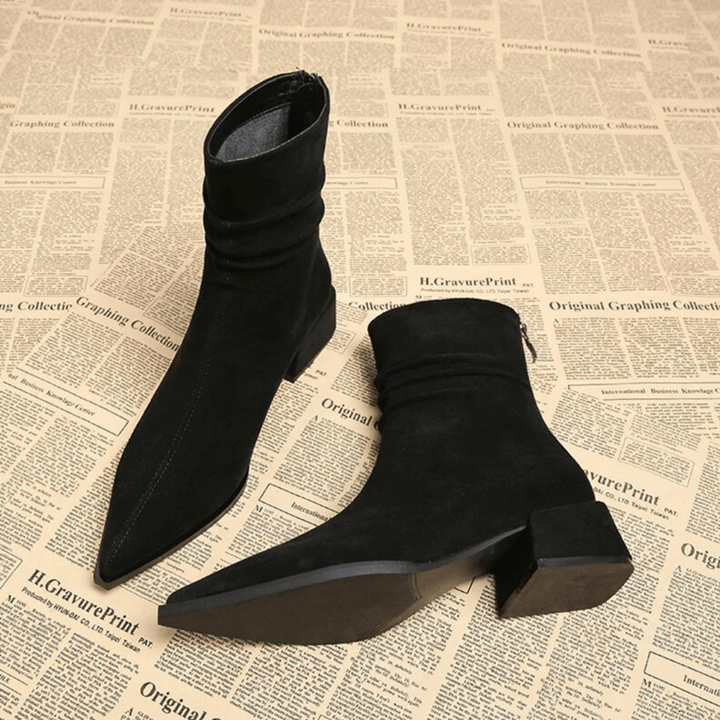 Fashionable women's block heel ankle boots with a sophisticated pointed toe, ideal for diverse outfits.