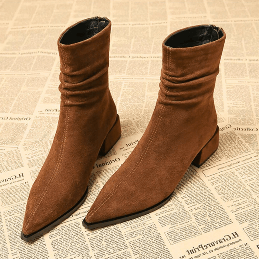 Women's black pointed toe ankle boots with a comfortable block heel. Stylish fall & winter fashion footwear.