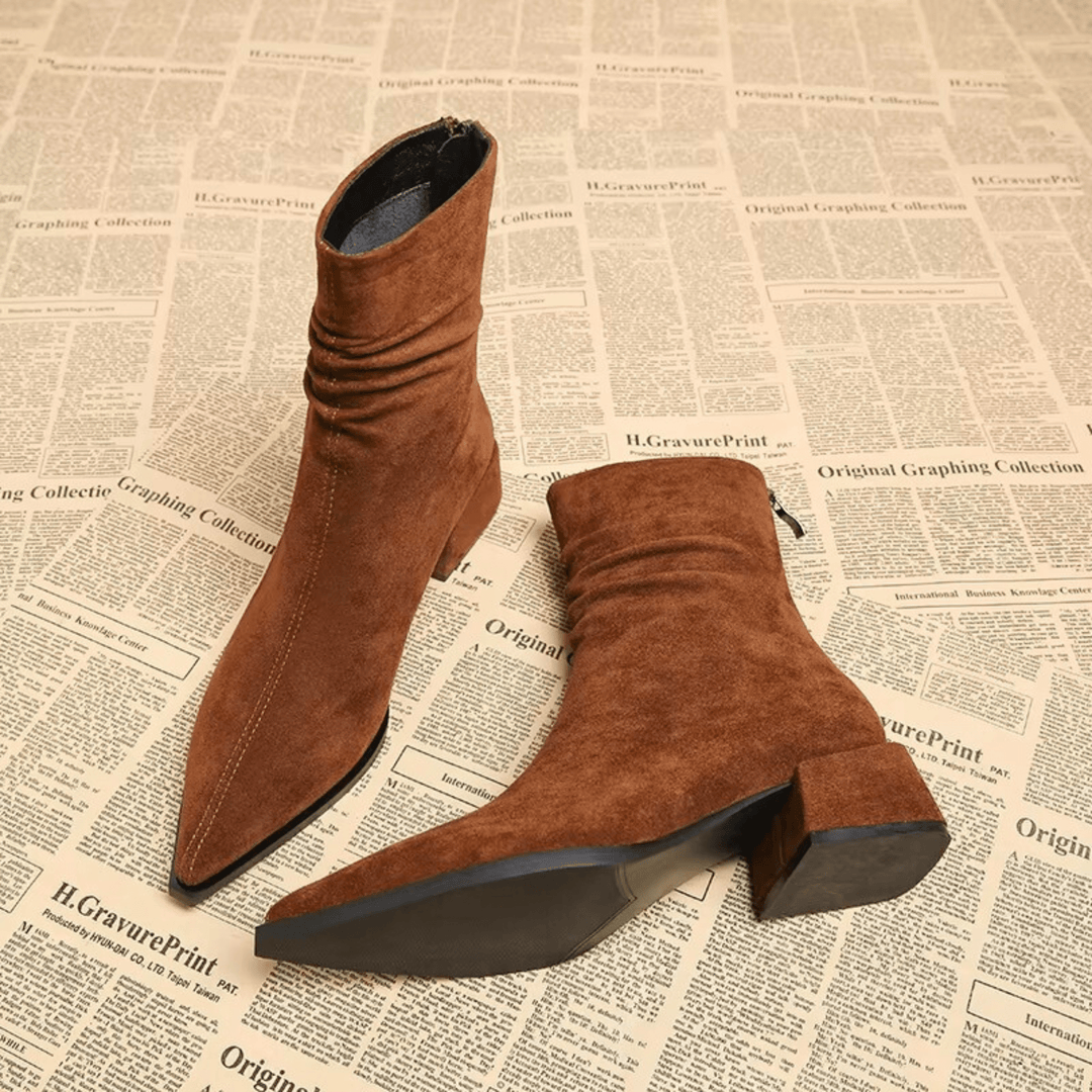 Stylish women's fall/winter ankle boots featuring a sleek pointed toe and fashionable block heel design.