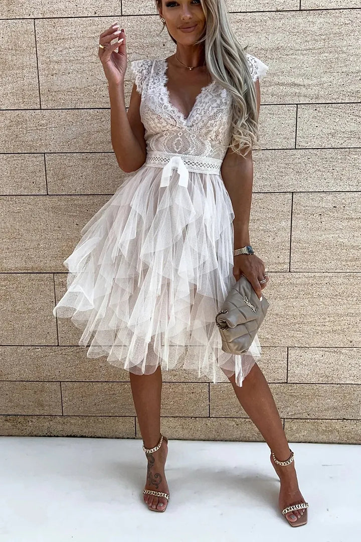 Sleeveless white mini cocktail dress for women, featuring elegant ruffles and a flattering ruched design.