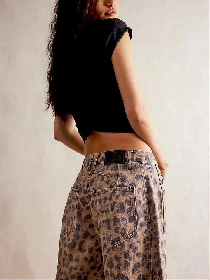 Bold women's high-waisted wide-leg leopard print jeans, fashionable patterned trousers for a modern look.