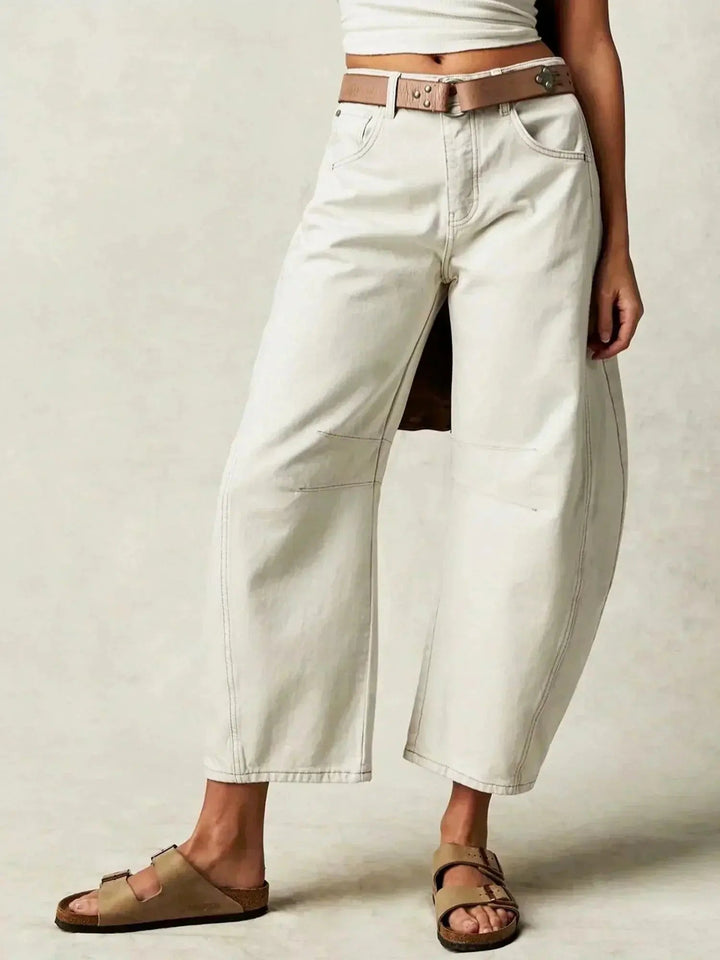 Women's high-waisted wide-leg jeans with a striking leopard print, ideal for statement wear.