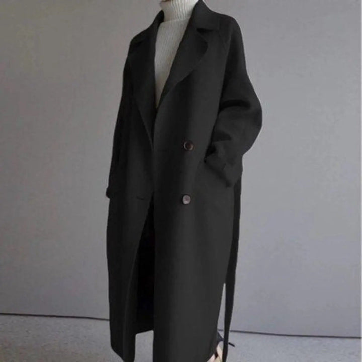 Stylish women's long double-breasted cashmere coat, perfect elegant outerwear for fall and winter seasons.