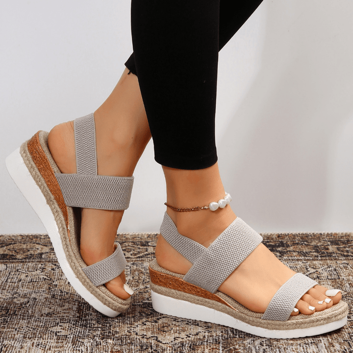 Easy slip-on women's platform sandals featuring adaptive comfort and trendy stretch straps for summer.