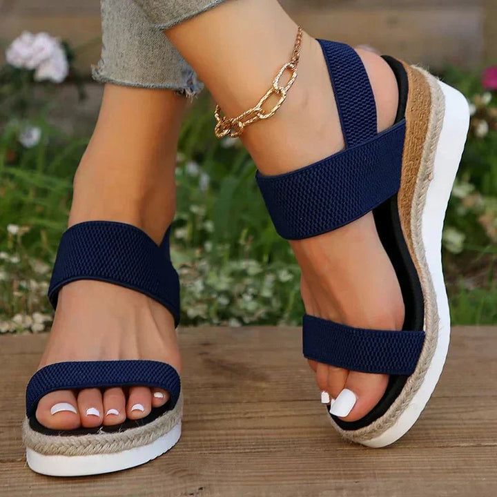 Detail of comfortable platform sole on women's adaptive summer sandals with stretch straps.