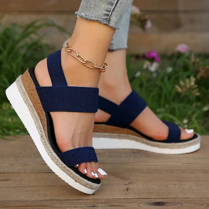 Stylish women's platform sandals with stretch straps, designed for adaptive comfort and summer fashion.