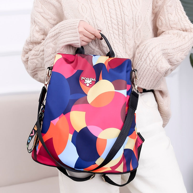 Organized interior of a women's anti-theft backpack with padded laptop sleeve and various secure pockets.