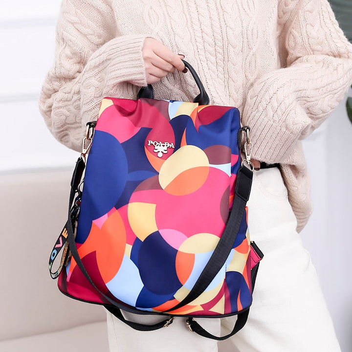 Organized interior of a women's anti-theft backpack with padded laptop sleeve and various secure pockets.