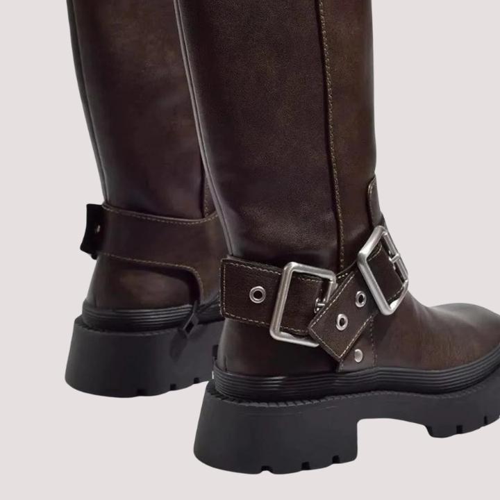 Fashionable women's knee-high boots featuring elegant buckle straps and a trendy chunky sole design.