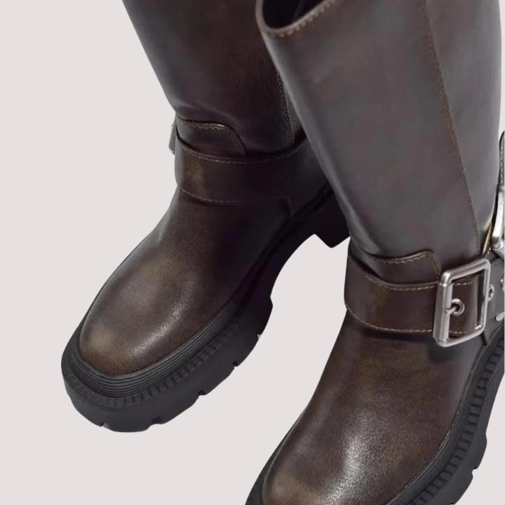 Durable women's knee-high boots with buckle straps, offering comfort and style for winter and fall fashion.