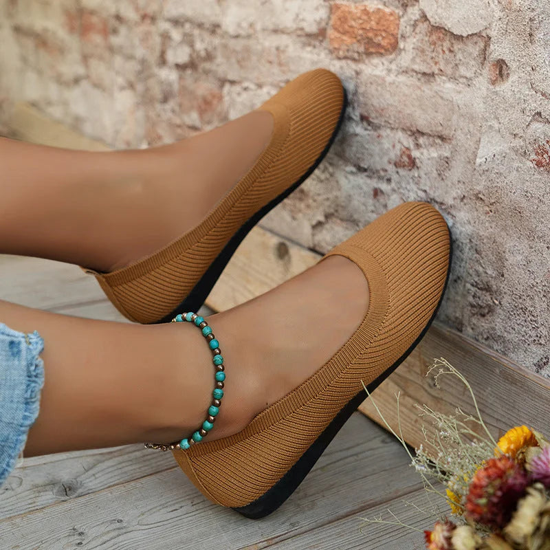 Classic black women's slip-on ballet flats, flexible & comfortable for everyday stylish footwear.